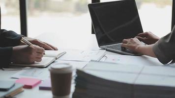 Financial analysts analyze business financial reports on a digital tablet planning investment project during a discussion at a meeting of corporate showing the results of their successful teamwork. video