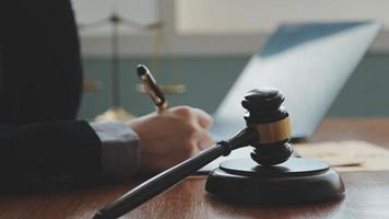 Male lawyer working with contract papers and wooden gavel on tabel in courtroom. justice and law ,attorney, court judge, concept. video