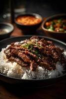 Traditional Korean Bulgogi dish. Thinly cut, grilled beef, served with rice and vegetables. photo