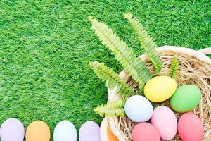 Easter eggs in the basket on grass photo