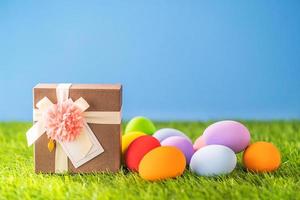 Easter eggs on grass and gift box photo