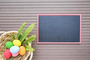 Easter eggs in the basket on and blackboard photo