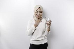 An Asian Muslim woman feels so thirsty because of the hot weather during the summer season while fasting photo