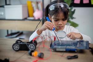 Asia students learn at home in coding robot cars and electronic board cables in STEM, STEAM, photo