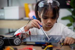 Asia students learn at home in coding robot cars and electronic board cables in STEM, STEAM, photo