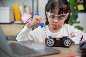 Asia students learn at home in coding robot cars and electronic board cables in STEM, STEAM, photo