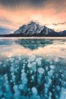 View of Abraham Lake with natural bubbles frost in the morning on winter at Banff national park photo