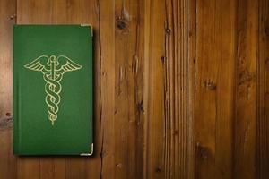 Medical book on a wooden desk photo