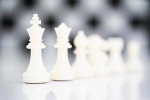 Set of white chess pieces on white background photo