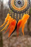 Handmade dream catcher with feathers threads and beads rope hanging photo