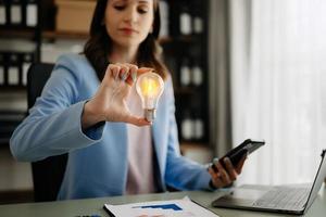 business woman hand showing creative business strategy with light bulb as concept photo