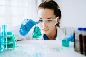 Female scientist researcher conducting an experiment in a laboratory. photo