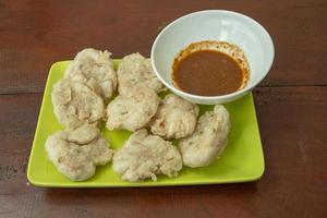 Close up photo of Cireng traditional food of Sundanese West Java. Fried flour with traditional chili sauce. The photo is suitable to use for Indonesia traditional food background, food poster.