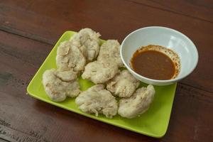 Close up photo of Cireng traditional food of Sundanese West Java. Fried flour with traditional chili sauce. The photo is suitable to use for Indonesia traditional food background, food poster.