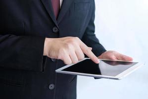 Businessman playing tablet- Hand Focused photo