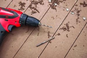 electric drill on wooden floor photo