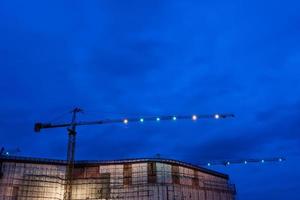 Construction site with cranes in twilight time