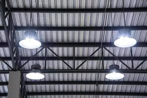 Metal roof structure with hanging light bulb and channel light photo