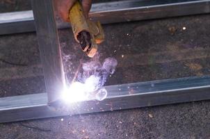 Arc welding of a steel at work site photo