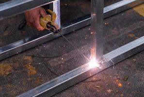 Arc welding of a steel at work site photo