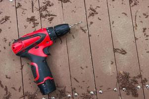 electric drill on wooden floor photo