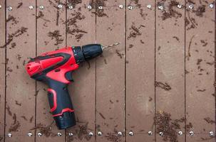 electric drill on wooden floor photo