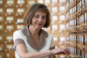 Elderly woman with library cells. Retro librarian. photo