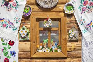 Part of a rustic window of a house decorated with towels. photo