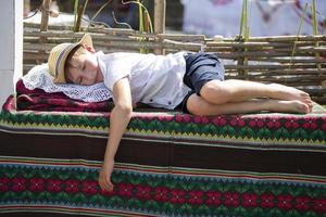 A Belarusian or Ukrainian boy sleeps on towels. Little ethnic boy is sleeping. photo