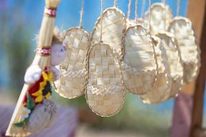 Birch bark souvenir sandals hang on a rope. photo