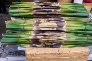 Kanom Jark, Thai sweetmeat made of flour, coconut and sugar with nipa plam leaves photo