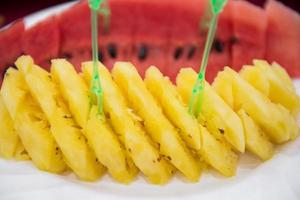 Sliced fruit stacks in watermelon and pineapple photo