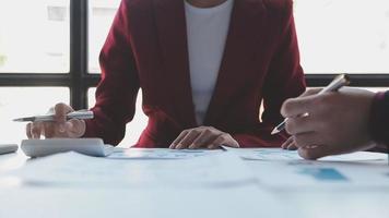 Financial analysts analyze business financial reports on a digital tablet planning investment project during a discussion at a meeting of corporate showing the results of their successful teamwork. video