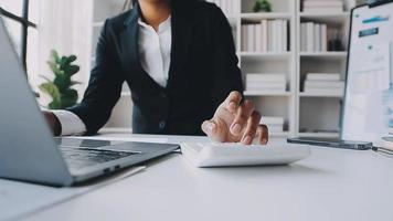 Financial analysts analyze business financial reports on a digital tablet planning investment project during a discussion at a meeting of corporate showing the results of their successful teamwork. video