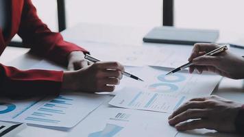 Financial analysts analyze business financial reports on a digital tablet planning investment project during a discussion at a meeting of corporate showing the results of their successful teamwork. video