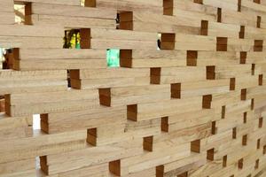 Wood wall made from small piece of timber, small square shape hole on broad.Beside perspective view of light brown wood and space background. photo