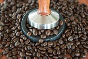 coffee tamper and roasted coffee in rubber base photo