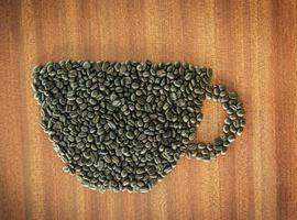 Coffee bean as a cup on wooden table photo