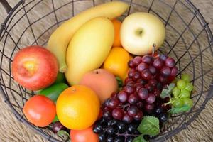 Basket and fresh fruits photo