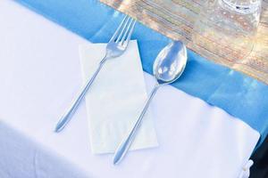 Table setting for meal with spoon, folk, and napkins photo