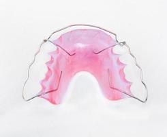 Retainer and brace on white background photo