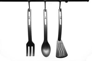 black kitchen utensils on white background photo