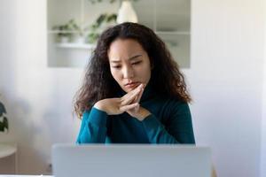 Asian Businesswoman Sitting at Her Desk Working on Laptop Computer in Big City Office. Confident Social Media Strategy Manager Plan Disruptive e-Commerce Campaign photo