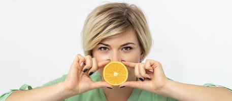 Dietitian holding slice of orange photo