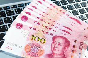 Yuan or RMB, Chinese Currency on laptop's keyboard photo