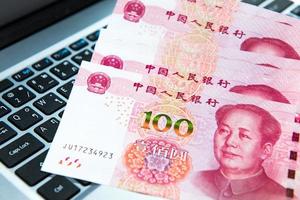 Yuan or RMB, Chinese Currency on laptop's keyboard photo