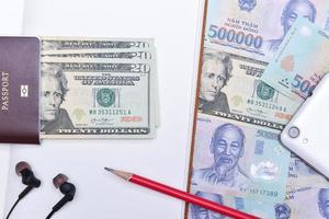 Vietnam and US dollar currency, notebook and passport photo