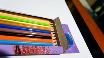 Set of collection of wooden coloring pencils in the box isolated on White Background. photo