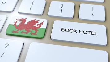 Book hotel in Wales with website online. Button on computer keyboard. Travel concept 3D animation. Book hotel text and national flag. 3D illustration photo