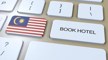 Book hotel in Malaysia with website online. Button on computer keyboard. Travel concept 3D animation. Book hotel text and national flag. 3D illustration photo